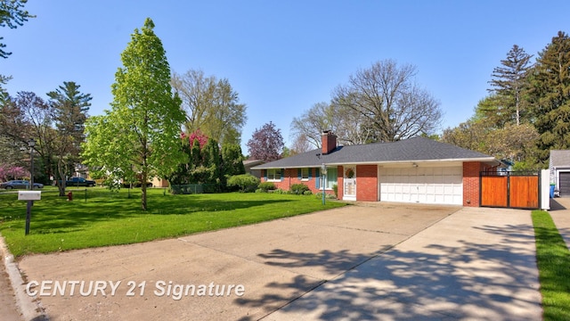 1415 Coolidge Ave, Saginaw, MI 48638 - view of front facade with an attached garage, a chimney, brick siding, driveway, and a gate