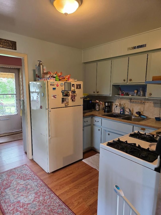 28465 John Hauk St, Garden City, MI 48135 - kitchen featuring white appliances, light wood-style flooring, and a sink
