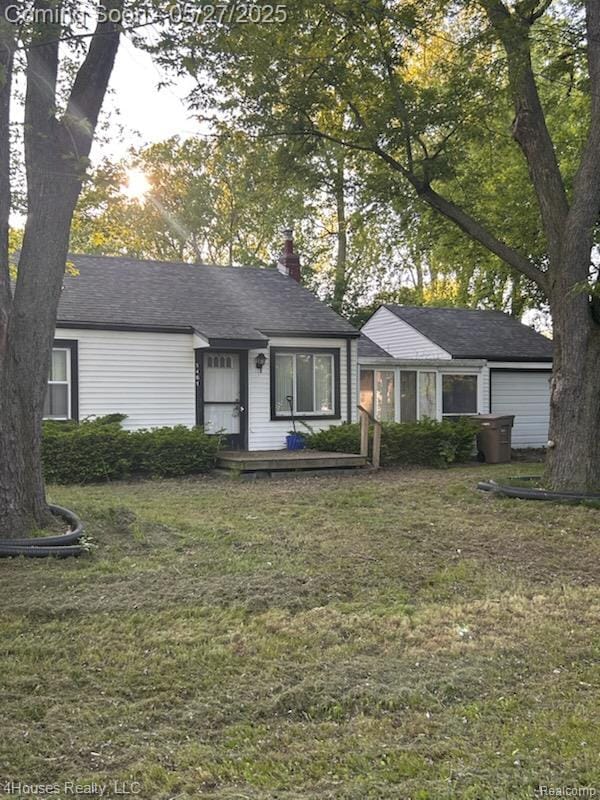 1461 Stirling Ave, Pontiac, MI 48340 - view of front of house featuring a chimney, a front lawn, and a garage