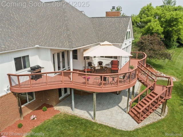 2449 Woodvale Trl, Brighton, MI 48114 - back of house with roof with shingles, a chimney, a wooden deck, and a patio area