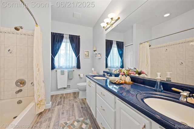 2449 Woodvale Trl, Brighton, MI 48114 - bathroom with healthy amount of natural light, double vanity, shower / tub combo with curtain, and wood finished floors