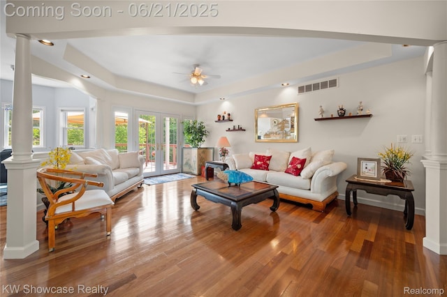 2449 Woodvale Trl, Brighton, MI 48114 - living area featuring ornate columns, a tray ceiling, ceiling fan, wood finished floors, and french doors