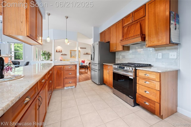 2449 Woodvale Trl, Brighton, MI 48114 - kitchen featuring appliances with stainless steel finishes, brown cabinets, custom range hood, and light stone countertops