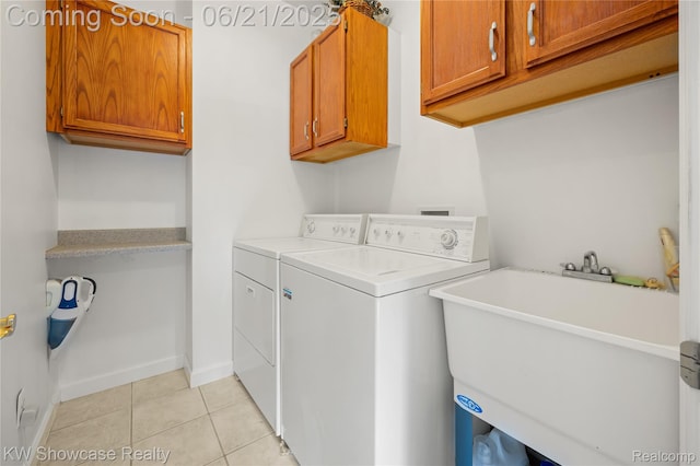 2449 Woodvale Trl, Brighton, MI 48114 - laundry room featuring cabinet space, separate washer and dryer, and light tile patterned floors