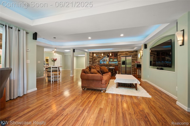 2449 Woodvale Trl, Brighton, MI 48114 - living area featuring a raised ceiling, wood finished floors, and recessed lighting