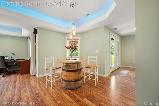 2449 Woodvale Trl, Brighton, MI 48114 - dining space with wood finished floors, healthy amount of natural light, a raised ceiling, and a desk