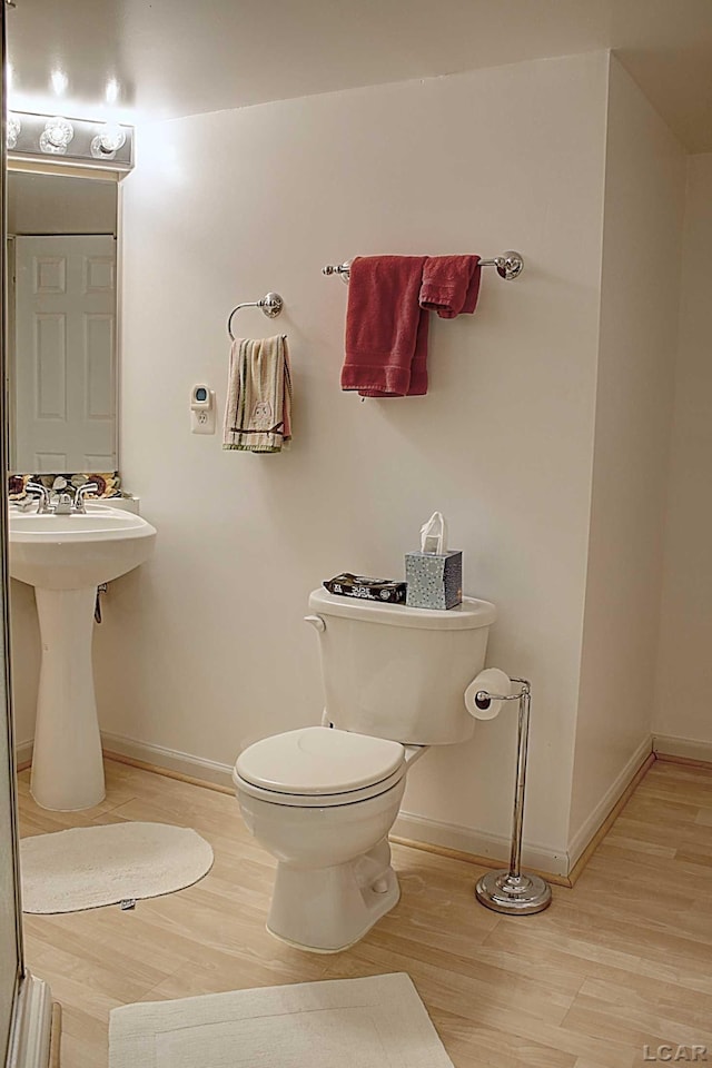 9299 Parkland Dr, Ypsilanti, MI 48197 - bathroom with wood finished floors, baseboards, and toilet