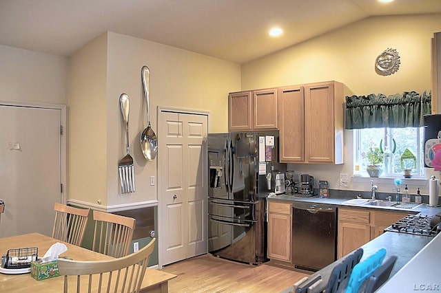 9299 Parkland Dr, Ypsilanti, MI 48197 - kitchen with black fridge with ice dispenser, dishwasher, a sink, light wood finished floors, and lofted ceiling