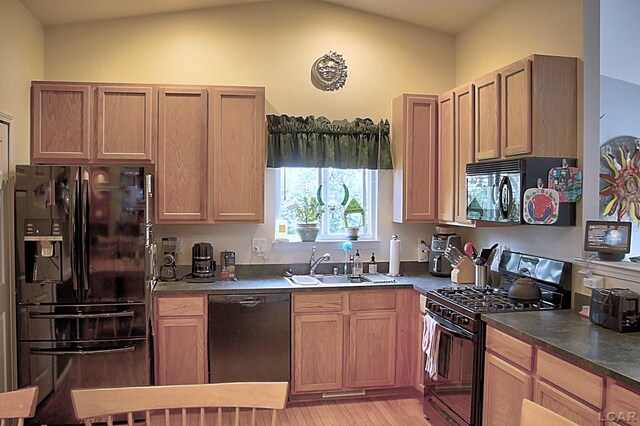 9299 Parkland Dr, Ypsilanti, MI 48197 - kitchen featuring black appliances, light wood-style floors, a sink, dark countertops, and lofted ceiling