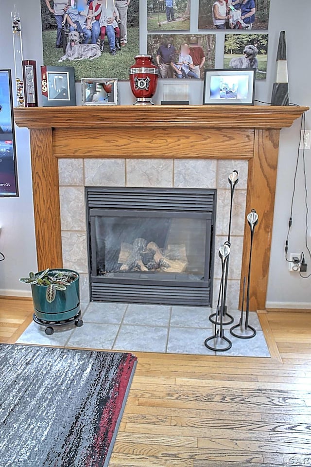 9299 Parkland Dr, Ypsilanti, MI 48197 - detailed view of a tile fireplace, baseboards, and wood finished floors