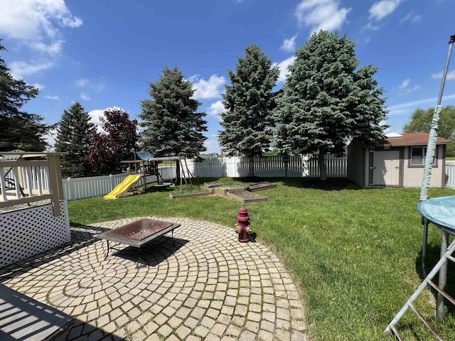 9299 Parkland Dr, Ypsilanti, MI 48197 - view of yard with a storage shed, an outbuilding, a patio, a playground, and an outdoor fire pit