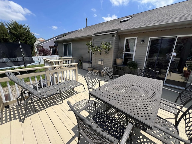 9299 Parkland Dr, Ypsilanti, MI 48197 - wooden deck with a trampoline and outdoor dining space