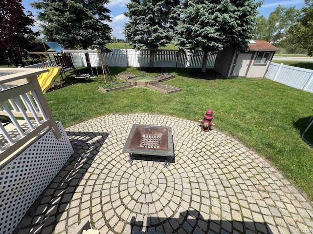9299 Parkland Dr, Ypsilanti, MI 48197 - view of patio / terrace featuring a playground, a shed, a vegetable garden, and an outbuilding