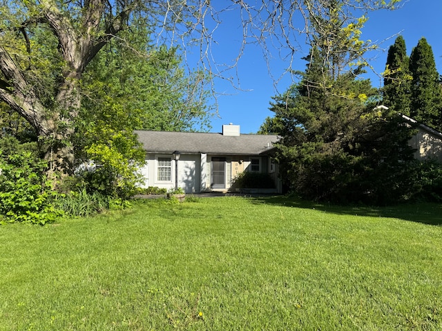 8610 N Waumegah Rd, Clarkston, MI 48348 - view of front facade featuring a front yard and a chimney