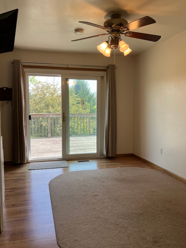 11300 Hegel Rd, Goodrich, MI 48438 - unfurnished living room featuring wood finished floors, a ceiling fan, and baseboards