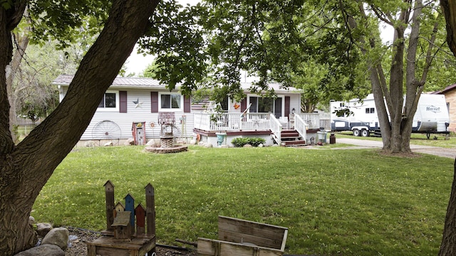 225 Myers Rd, Lapeer, MI 48446 - view of front of property with a front lawn, a deck, and metal roof