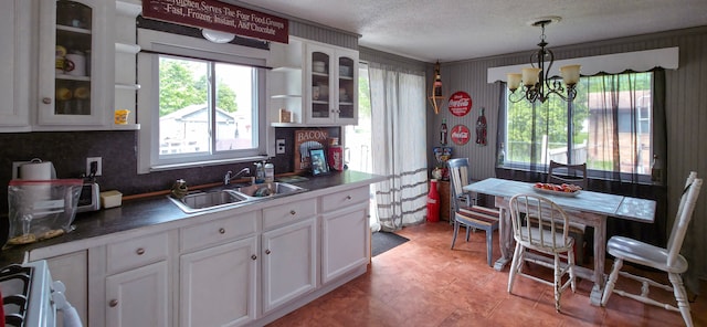 225 Myers Rd, Lapeer, MI 48446 - kitchen with a sink, a chandelier, white cabinets, and a textured ceiling