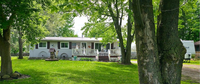 225 Myers Rd, Lapeer, MI 48446 - ranch-style house with a front yard, a deck, and metal roof