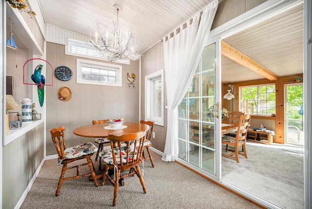 3309 Dumont Lake Dr, Allegan, MI 49010 - carpeted dining area with plenty of natural light, a chandelier, baseboards, and wooden walls