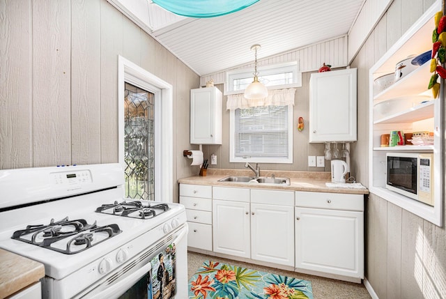 3309 Dumont Lake Dr, Allegan, MI 49010 - kitchen featuring white appliances, a sink, white cabinets, vaulted ceiling, and wood walls