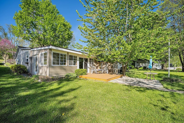 3309 Dumont Lake Dr, Allegan, MI 49010 - rear view of house featuring a wooden deck, a yard, and a patio area