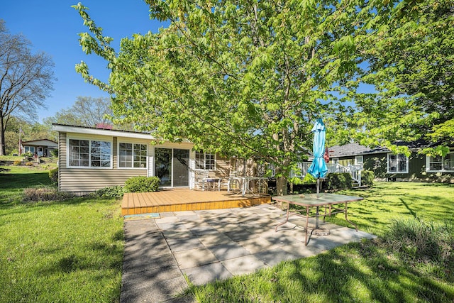 3309 Dumont Lake Dr, Allegan, MI 49010 - back of house featuring a wooden deck, a yard, and a patio
