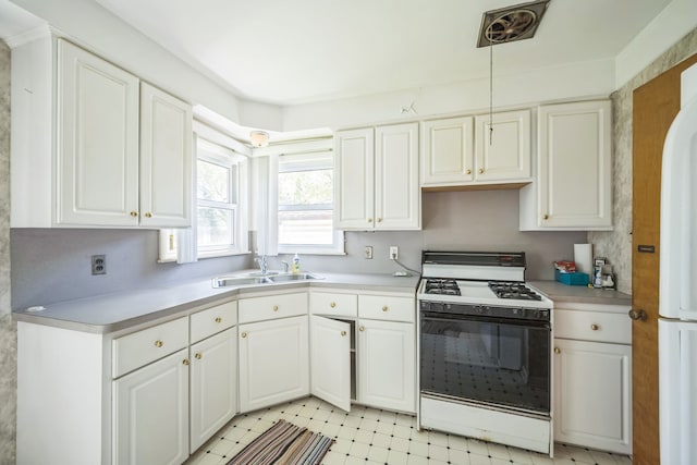 13970 Crosley, Redford, MI 48239 - kitchen featuring gas range, a sink, light countertops, white cabinets, and light floors
