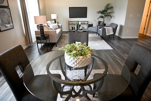 living room featuring baseboards and dark wood-style flooring