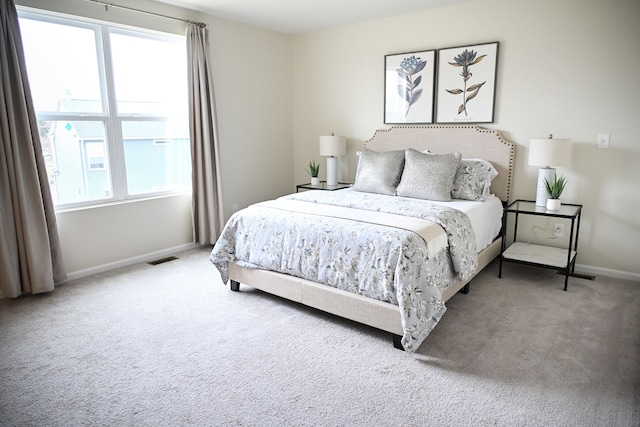 carpeted bedroom featuring baseboards