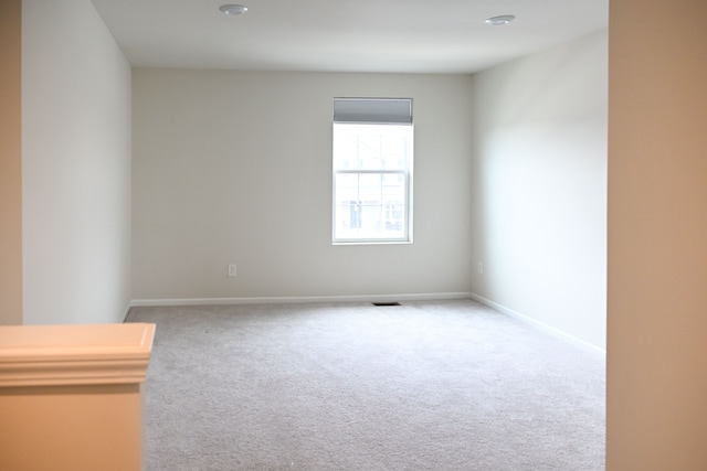 carpeted empty room with baseboards