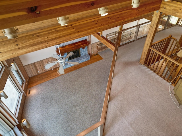 14427 Acorn Cove Trl, Battle Creek, MI 49017 - unfurnished living room with stairs, carpet flooring, and ceiling fan