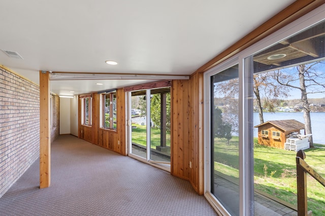 14427 Acorn Cove Trl, Battle Creek, MI 49017 - interior space with a water view, brick wall, and wood walls