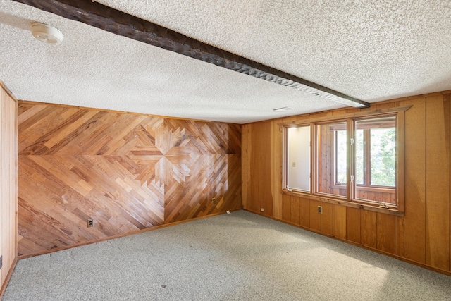 14427 Acorn Cove Trl, Battle Creek, MI 49017 - carpeted empty room with wooden walls, a textured ceiling, and a smoke detector