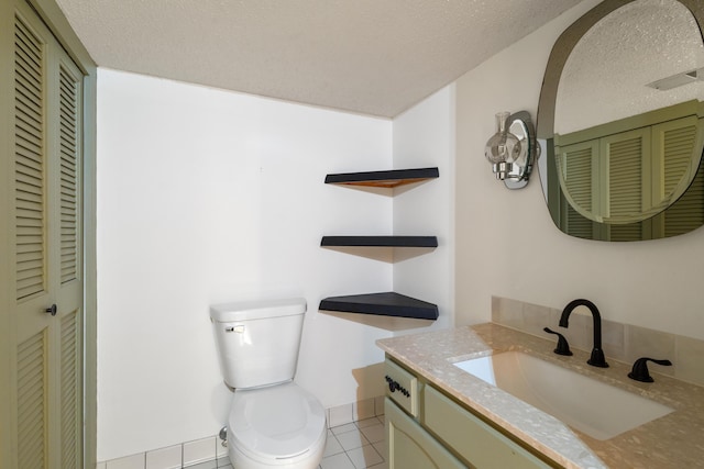 14427 Acorn Cove Trl, Battle Creek, MI 49017 - bathroom with a closet, tile patterned flooring, toilet, vanity, and a textured ceiling