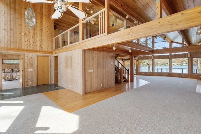 14427 Acorn Cove Trl, Battle Creek, MI 49017 - interior space featuring high vaulted ceiling, wood walls, stairs, and beam ceiling