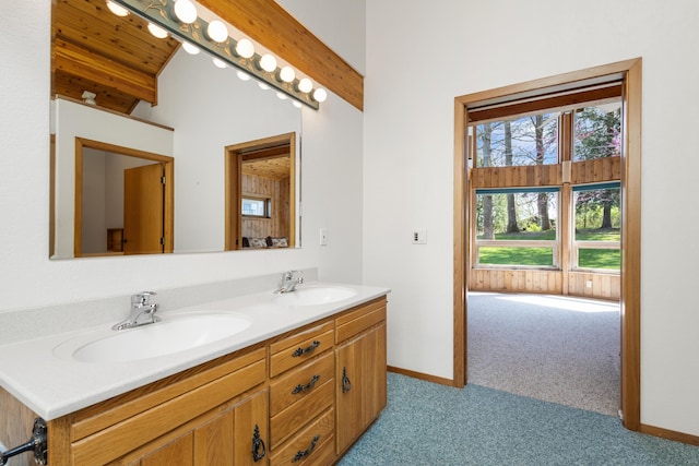14427 Acorn Cove Trl, Battle Creek, MI 49017 - bathroom with double vanity, baseboards, and carpet flooring