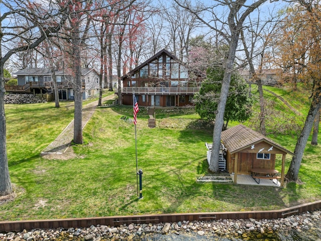 14427 Acorn Cove Trl, Battle Creek, MI 49017 - rear view of property with a wooden deck and a lawn