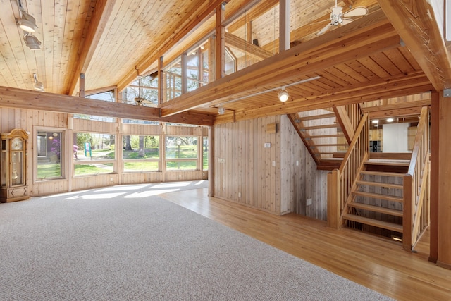 14427 Acorn Cove Trl, Battle Creek, MI 49017 - unfurnished living room with wood finished floors, wooden walls, stairs, ceiling fan, and wooden ceiling
