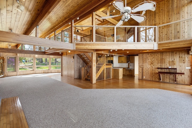 14427 Acorn Cove Trl, Battle Creek, MI 49017 - unfurnished living room with high vaulted ceiling, wood walls, ceiling fan, wood-type flooring, and wood ceiling