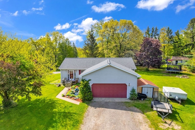 144 Westshore Dr, Jerome, MI 49249 - view of front of property with a storage unit, dirt driveway, an outbuilding, a front lawn, and a trampoline