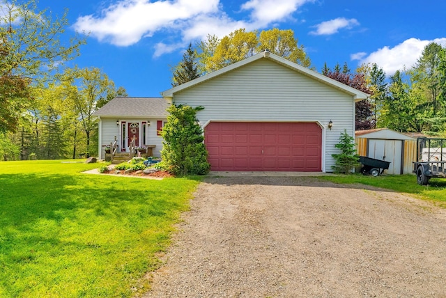 144 Westshore Dr, Jerome, MI 49249 - view of front facade with driveway, a storage unit, a front lawn, a garage, and an outdoor structure