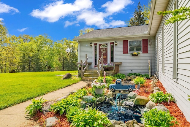 144 Westshore Dr, Jerome, MI 49249 - view of front of property with a front yard and roof with shingles