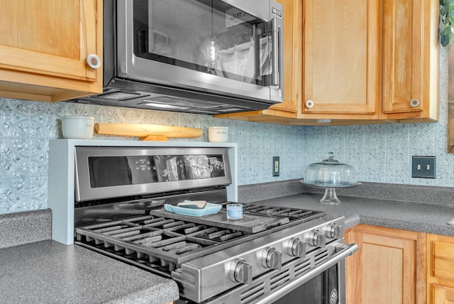 144 Westshore Dr, Jerome, MI 49249 - kitchen featuring stainless steel appliances, backsplash, dark countertops, and light brown cabinets