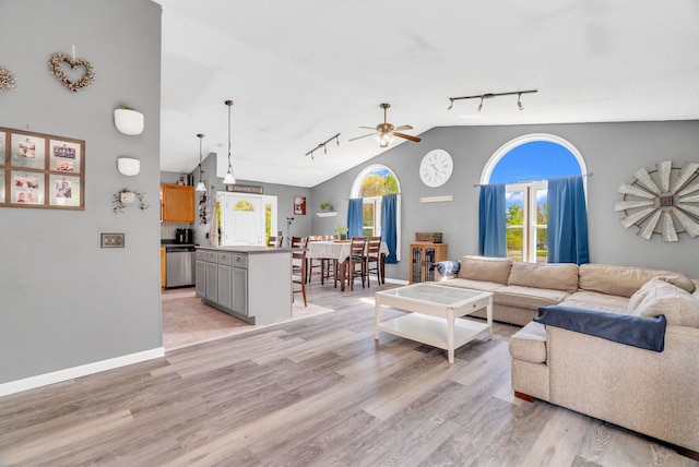 144 Westshore Dr, Jerome, MI 49249 - living area featuring rail lighting, a ceiling fan, light wood-style floors, lofted ceiling, and baseboards