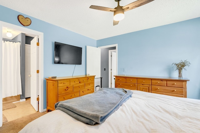 144 Westshore Dr, Jerome, MI 49249 - bedroom with a ceiling fan, baseboards, and a textured ceiling
