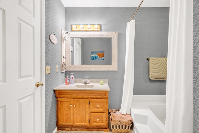 144 Westshore Dr, Jerome, MI 49249 - bathroom featuring wallpapered walls, a bathtub, vanity, and a shower with shower curtain