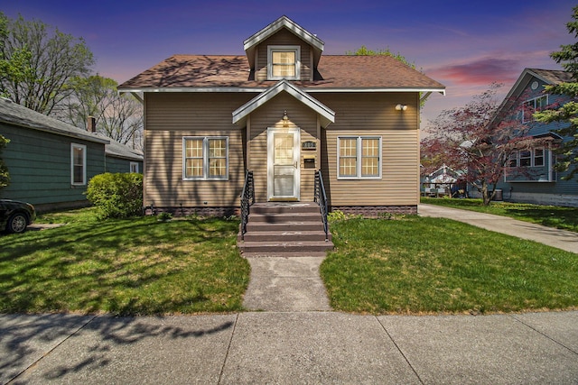 805 E Filer St, Ludington, MI 49431 - bungalow-style house featuring a front yard
