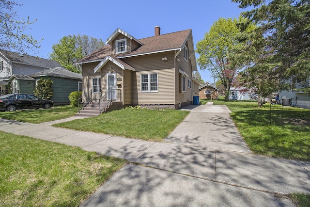 805 E Filer St, Ludington, MI 49431 - view of front of property featuring a chimney and a front lawn