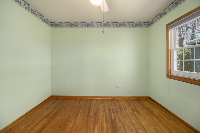 805 E Filer St, Ludington, MI 49431 - unfurnished room featuring hardwood / wood-style flooring, baseboards, and a ceiling fan