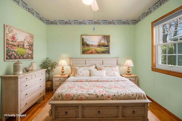 805 E Filer St, Ludington, MI 49431 - bedroom with light wood-style floors and baseboards